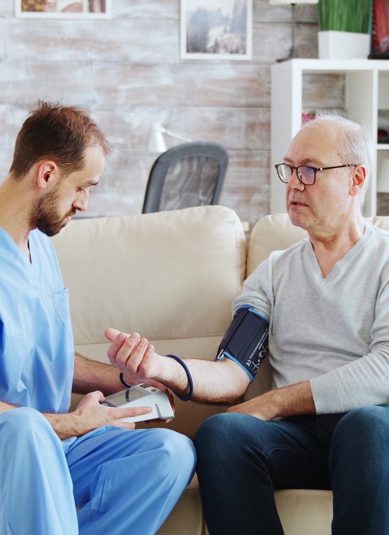 male-nurse-measuring-blood-pressure-of-a-man-pensioner.jpg